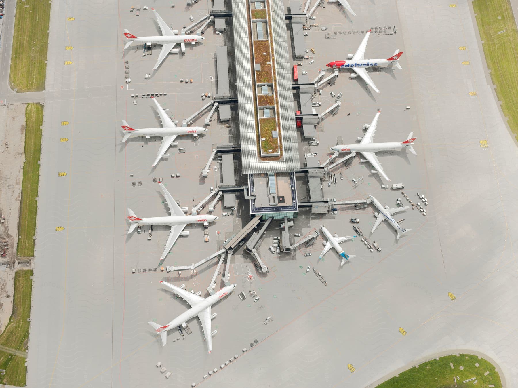 Airplanes parked on the tarmac near a hangar