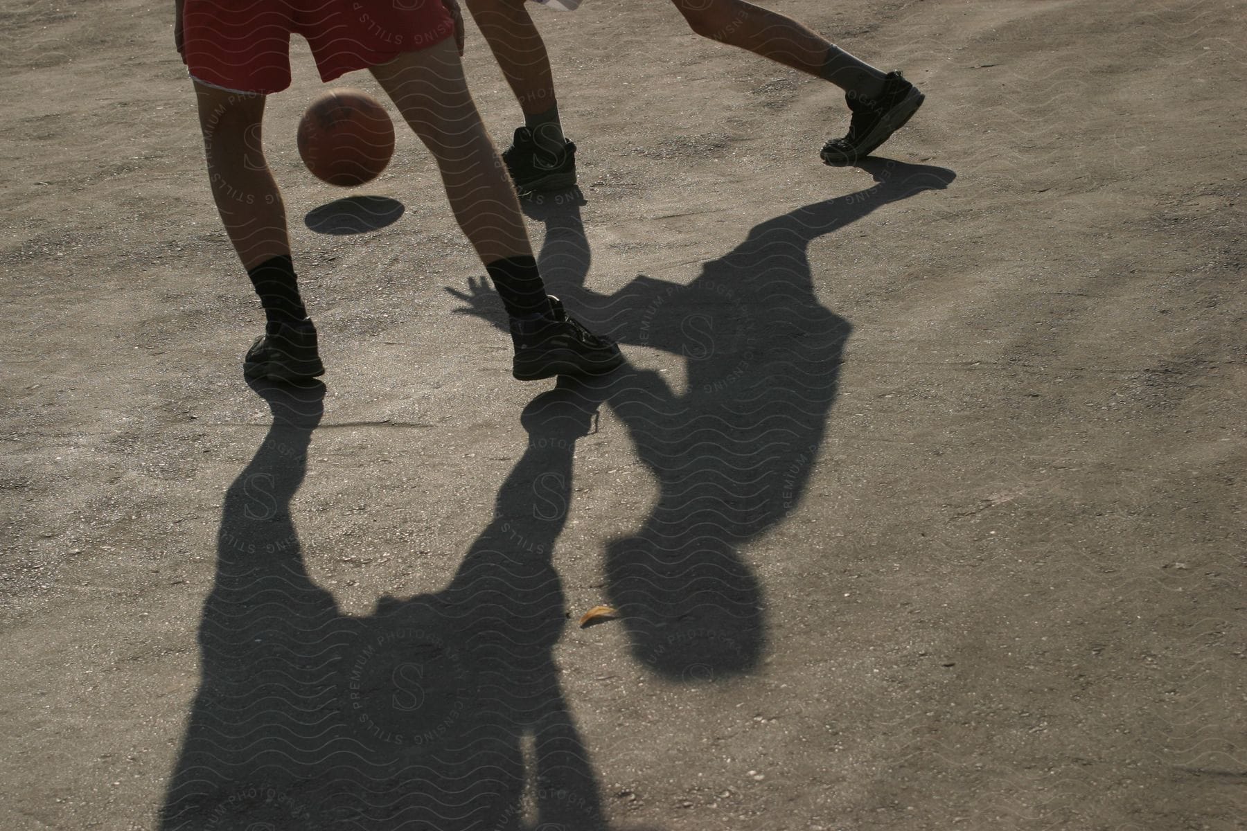 Two people playing soccer outdoors during the day