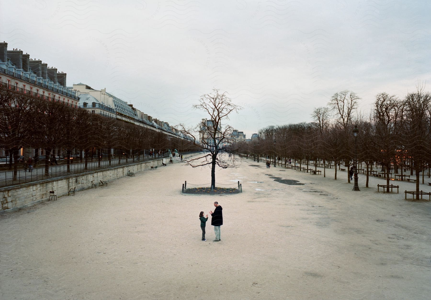 A man and a child in Tuileries Garden in Paris