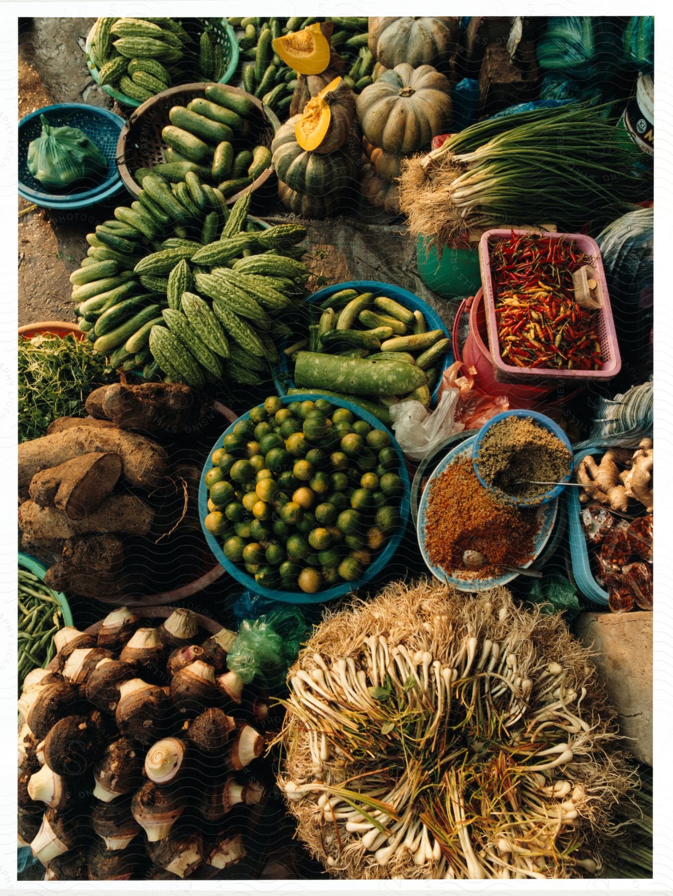 Fresh fruits and vegetables arranged in a basket on the ground