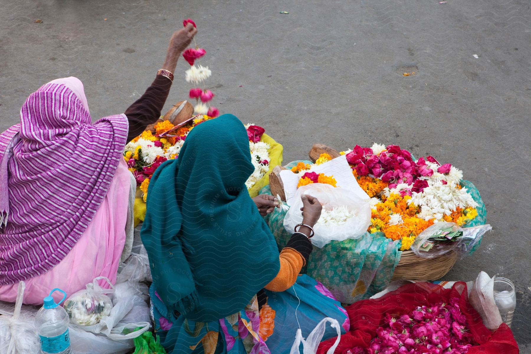 Two adults one female arranging flowers