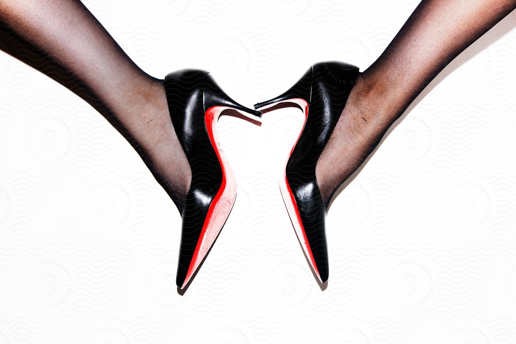 Closeup of someone wearing high heel shoes indoors