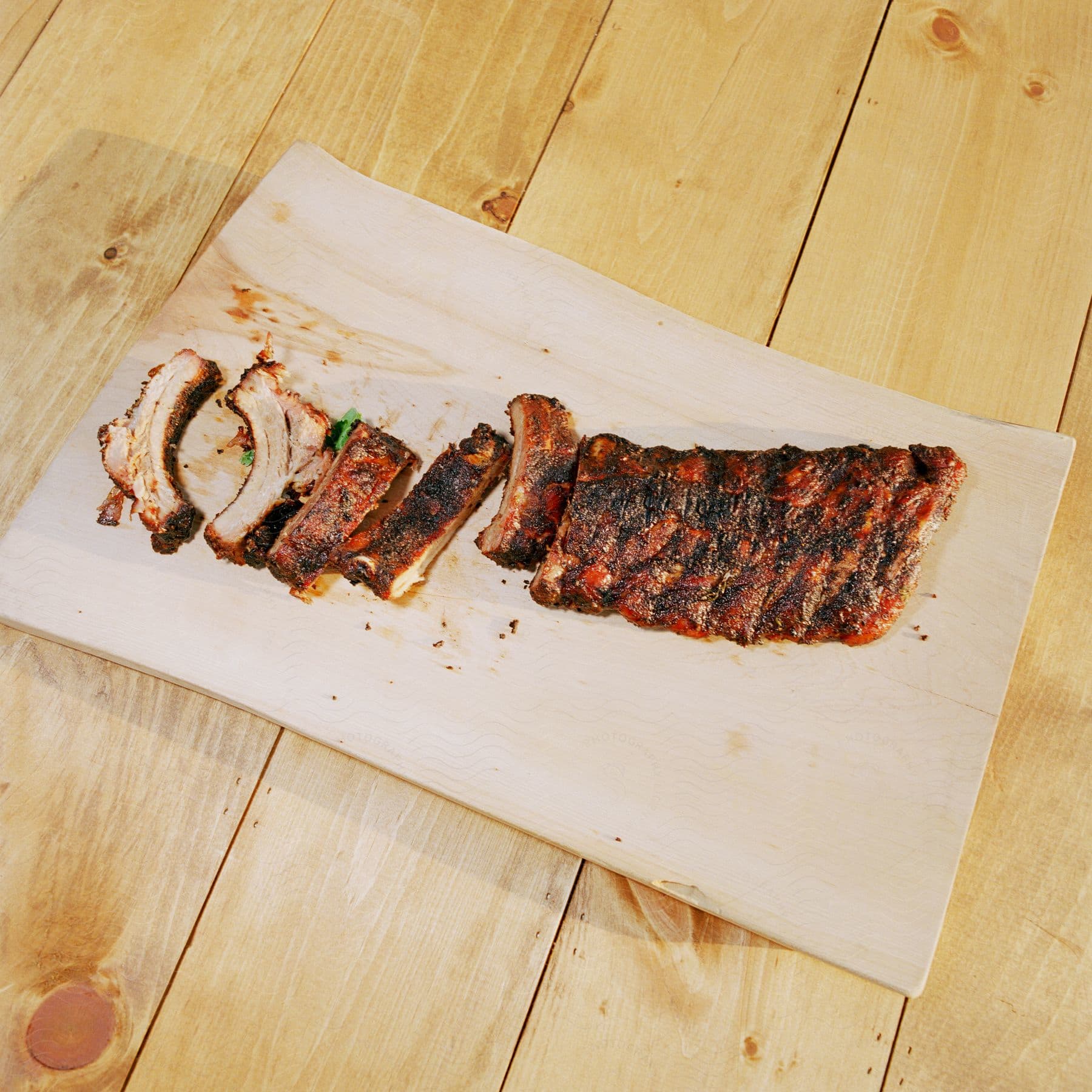 A rectangular wooden surface with pork and beef meat