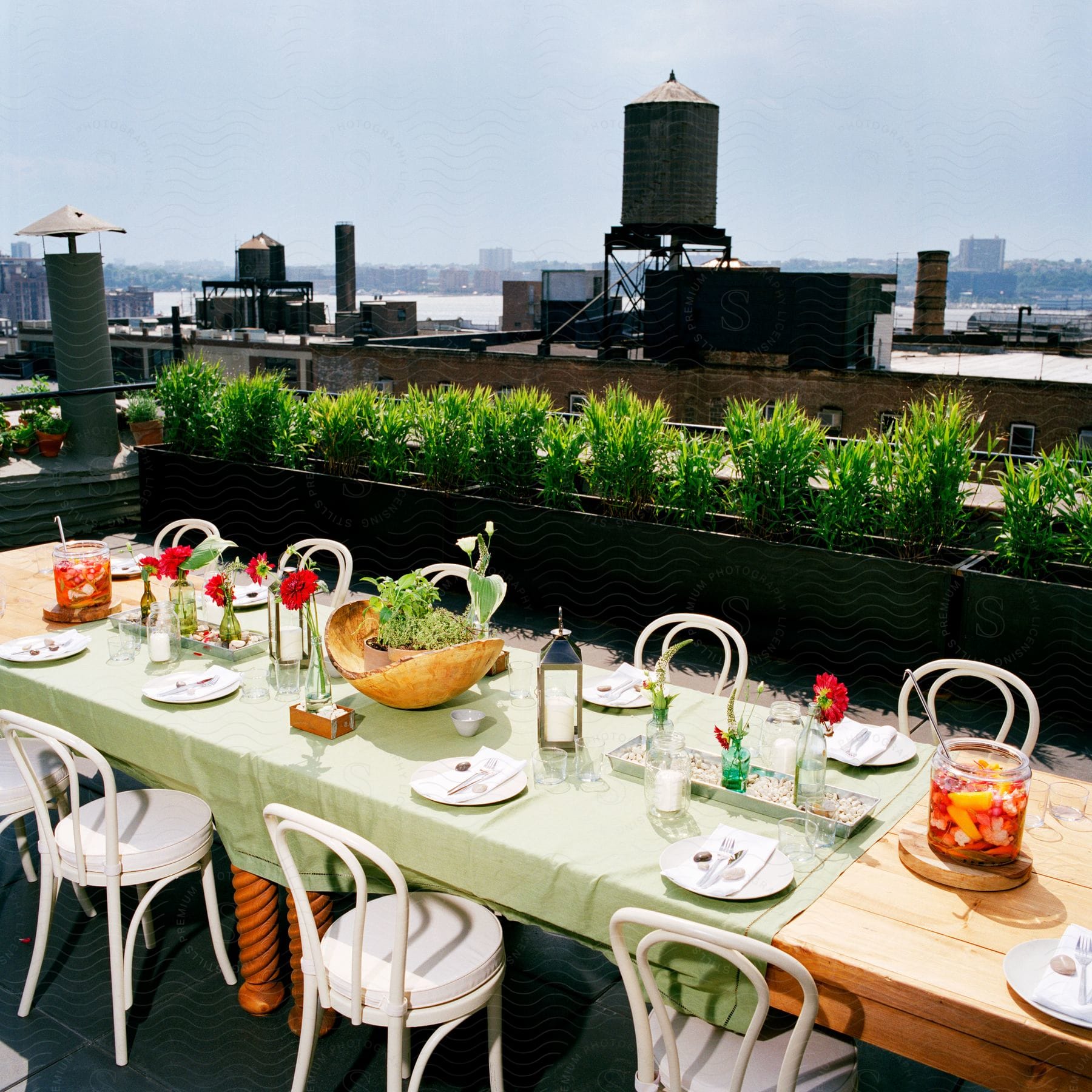 A scene of a dining table set with food and drink on an outdoor terrace