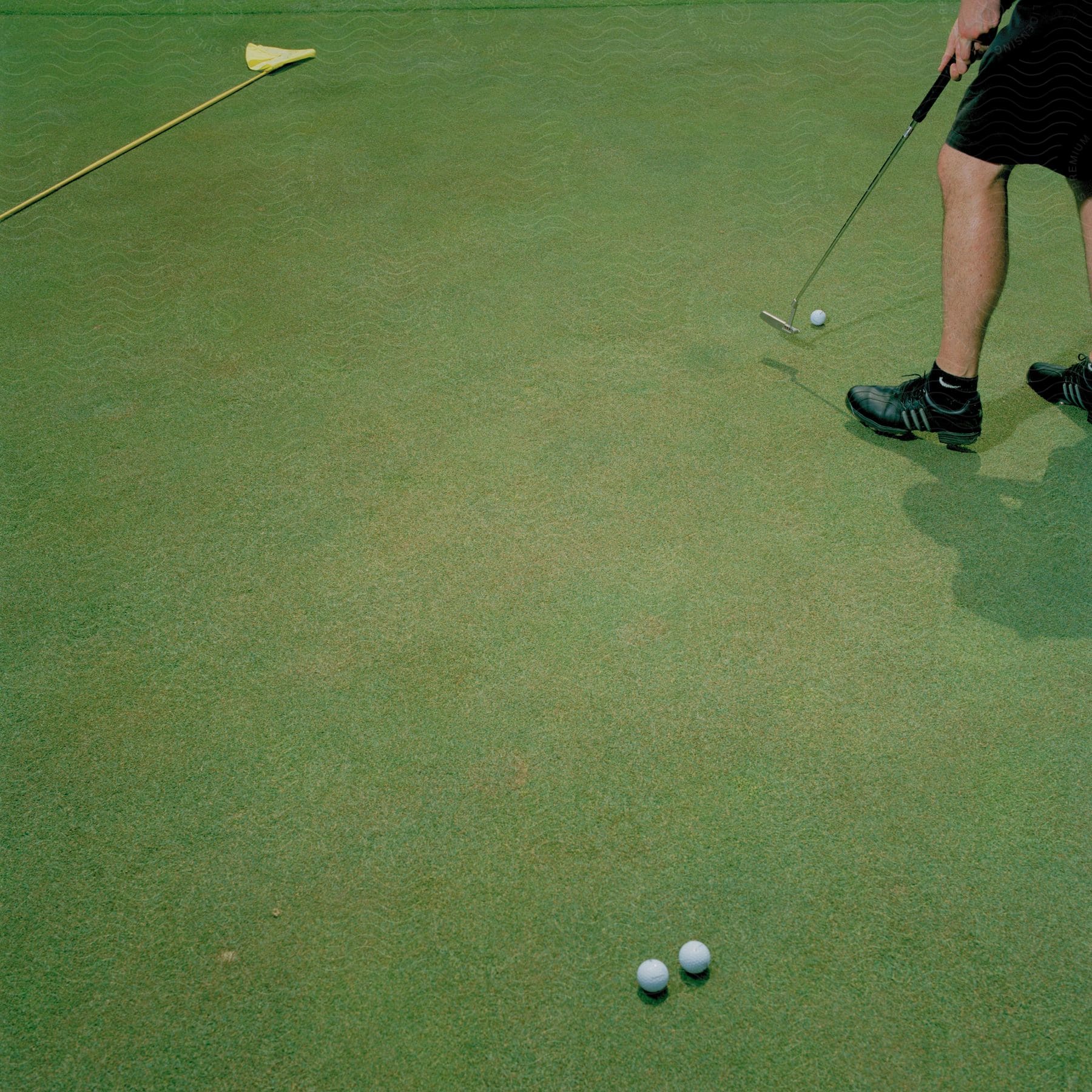 A person playing golf with their face not visible