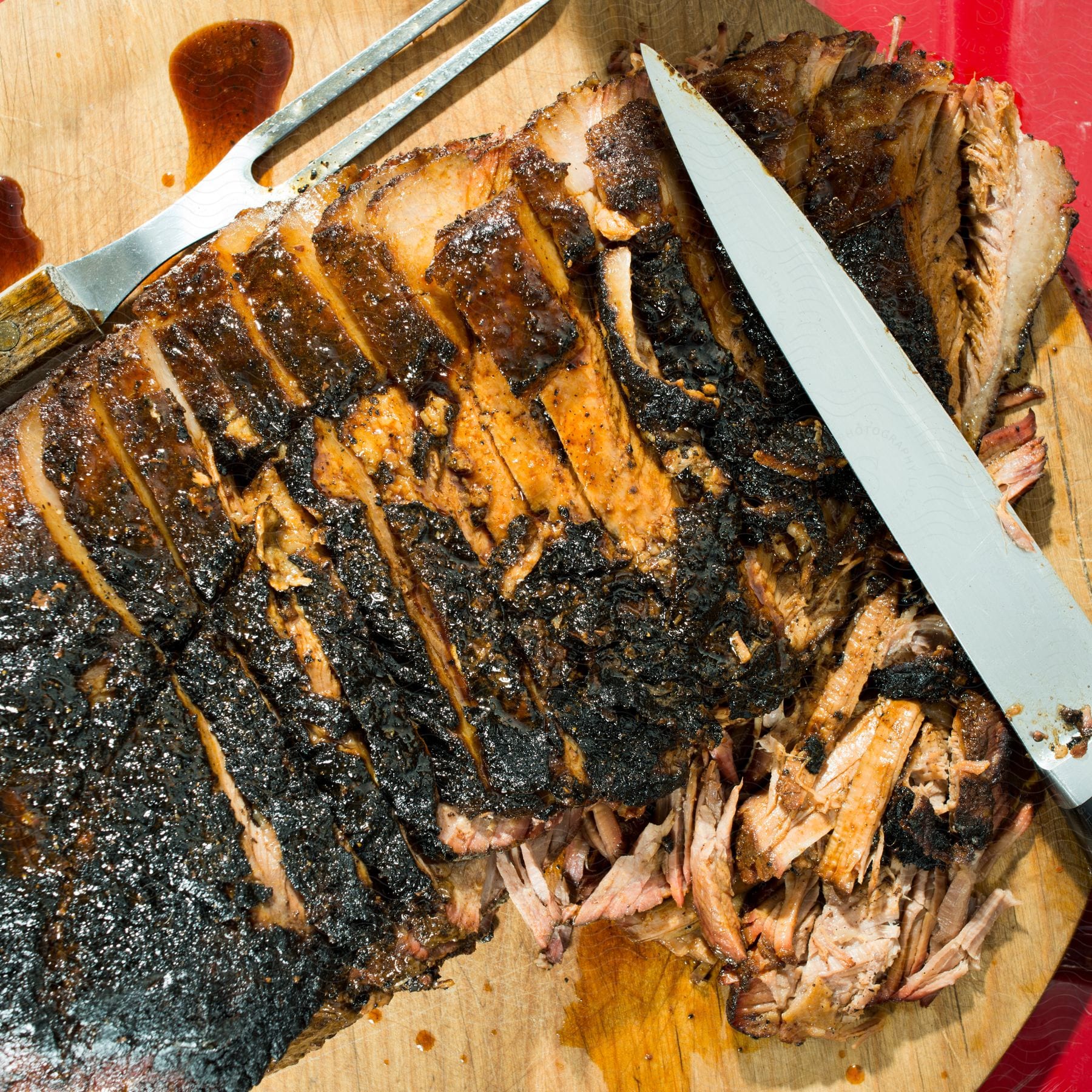 A closeup view of sliced brisket and a knife
