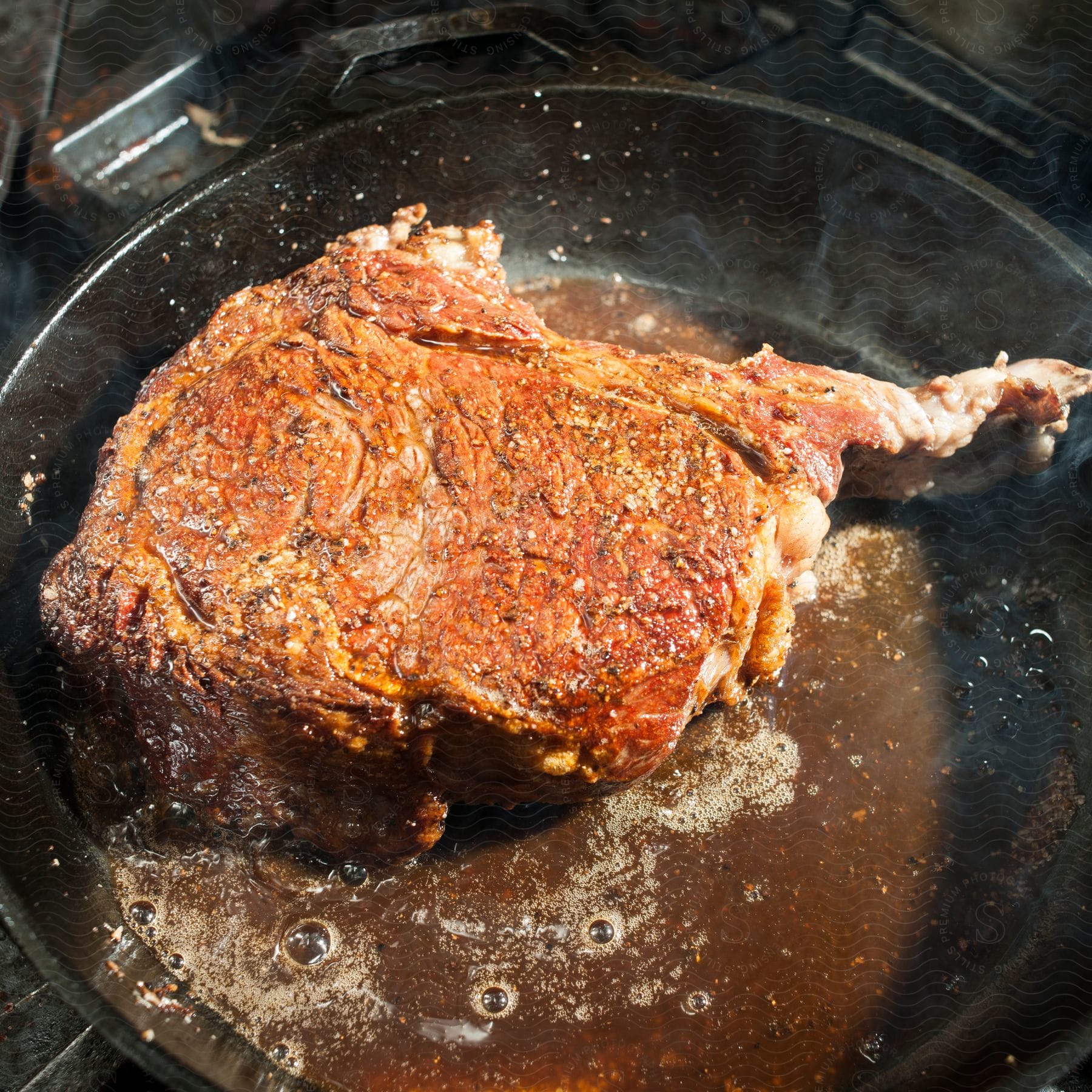 Meat cooking in a pan on the stove