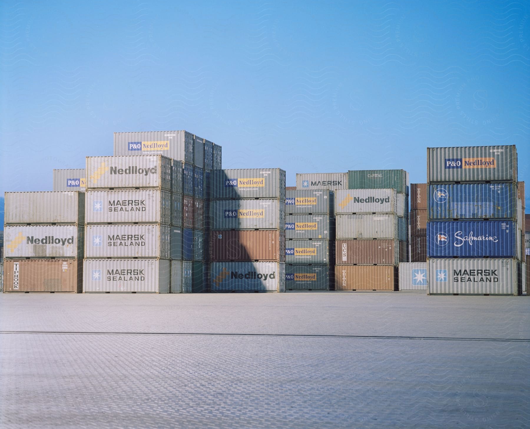 Multiple stacked shipping containers in a shipping yard