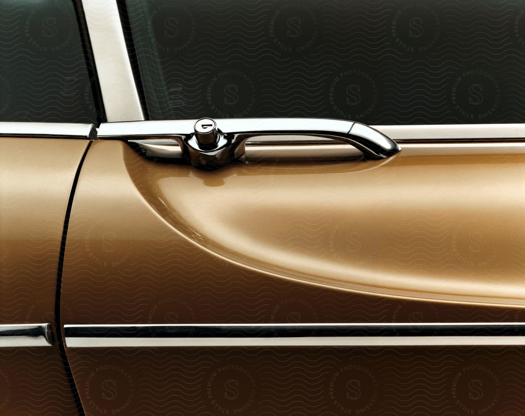 Close up of a retro chrome style car door handle with a push button