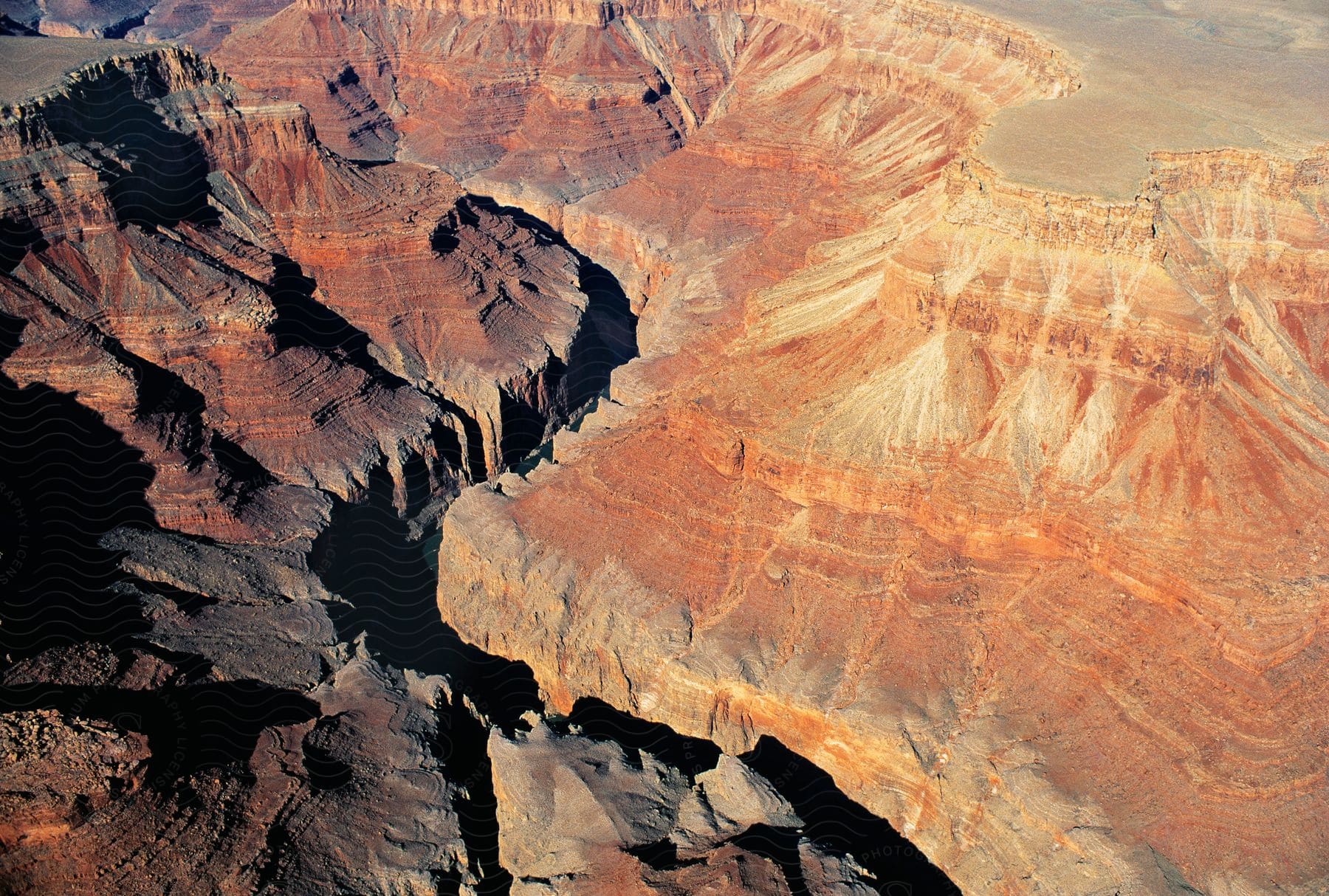 Aerial view of a mountainous landscape with sunlight shining down on it