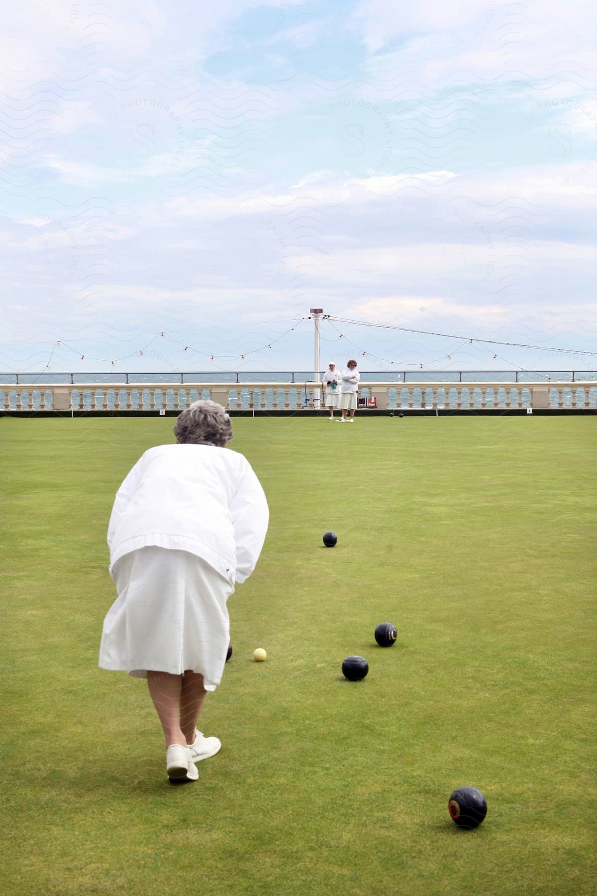 Elderly women playing lawn bowling