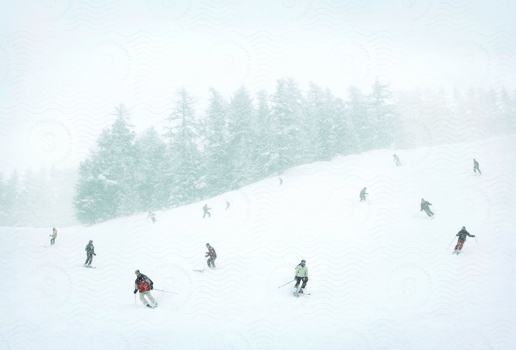 A group of skiers on icy terrain with snow falling from the sky