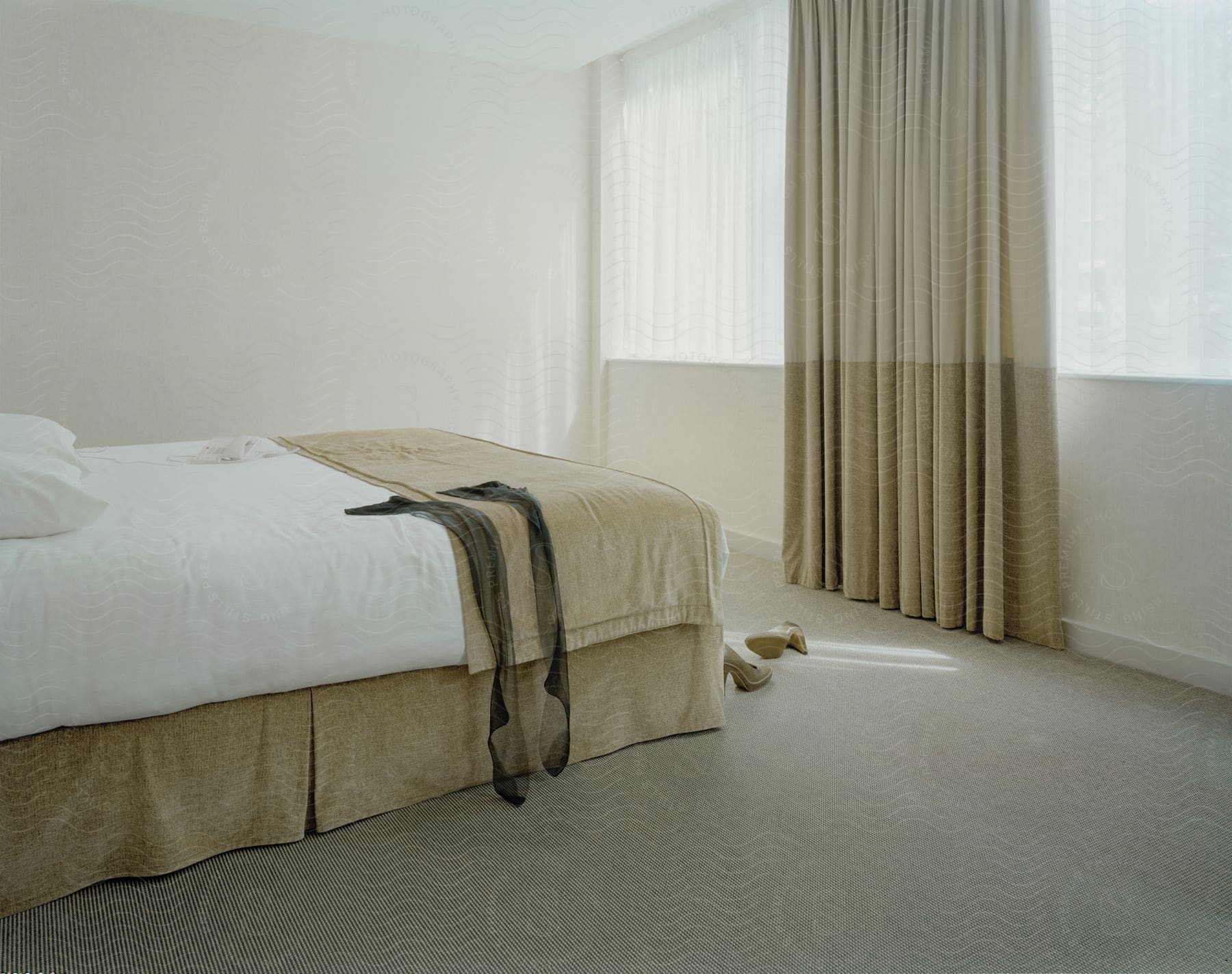 Interior decor of a bedroom in white and beige with furniture and curtains