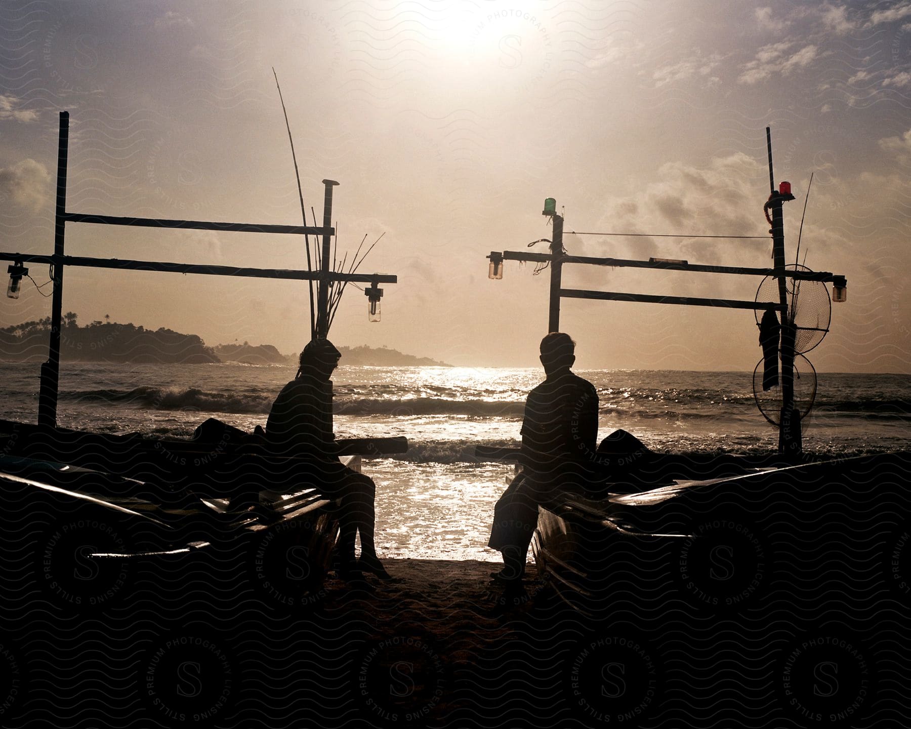 Two people in separate canoes on the sea