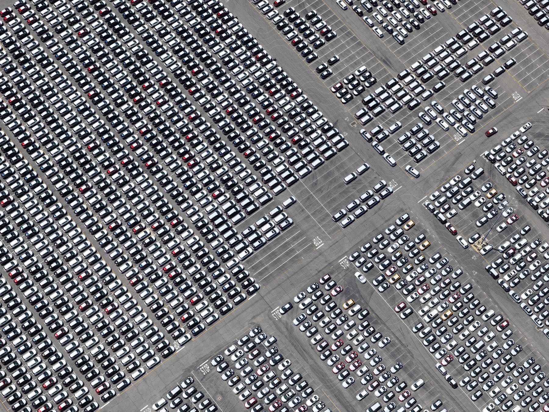 Aerial view of a large parking lot filled with cars