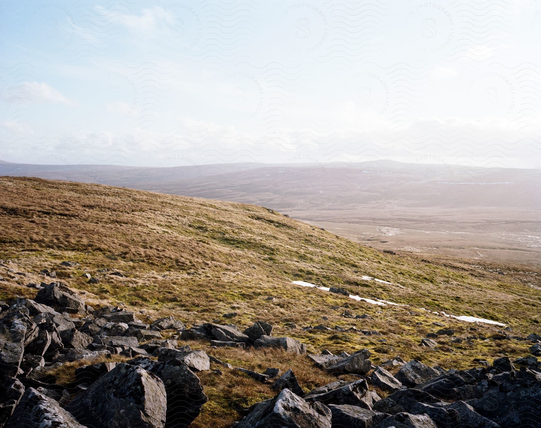 A serene mountain landscape with a cloudy sky