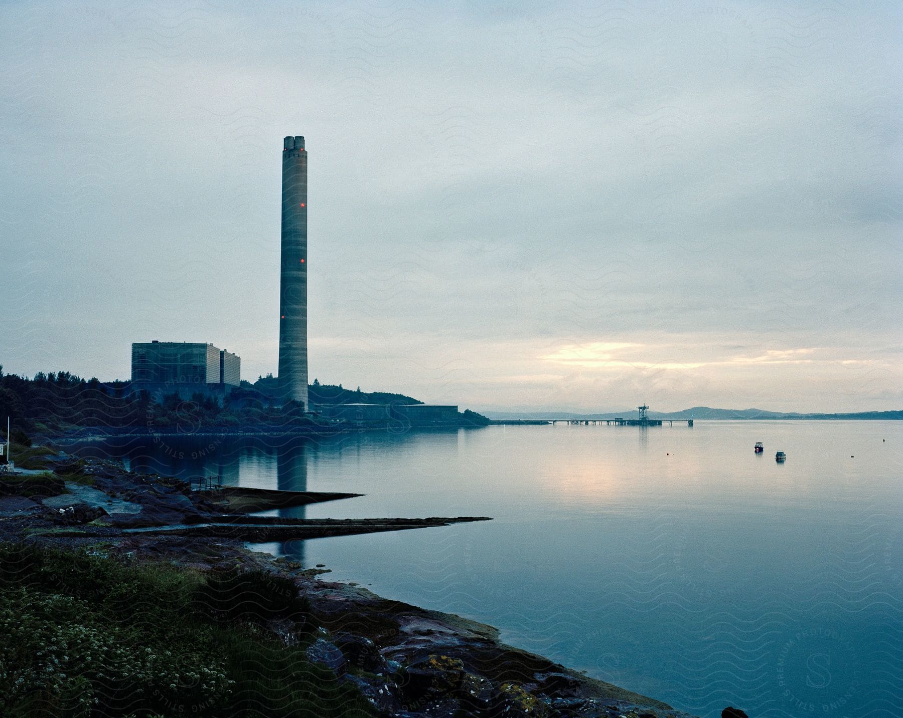 A shoreline with a tall tower building visible in the background