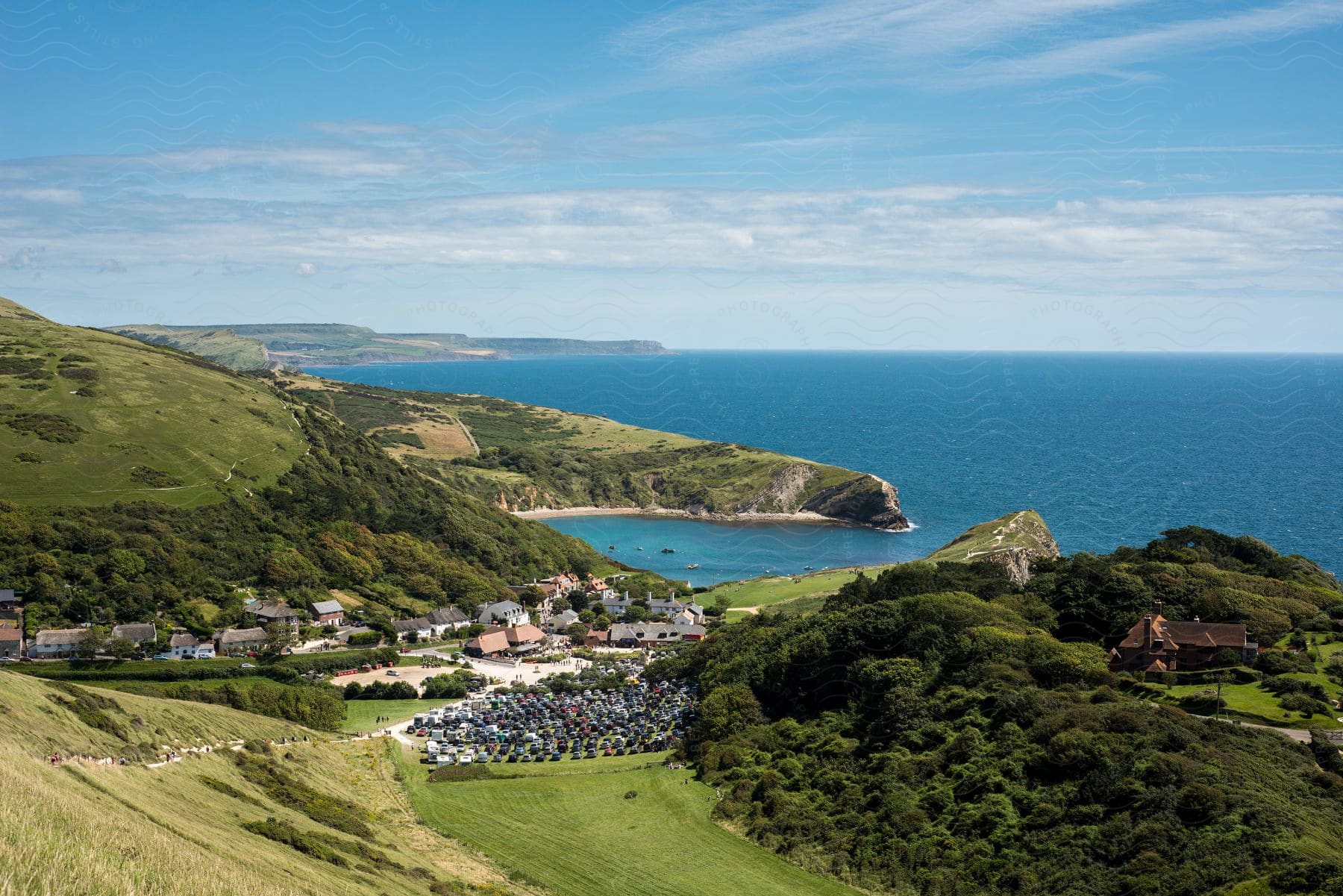 A small town sits at the foot of hills by the coast