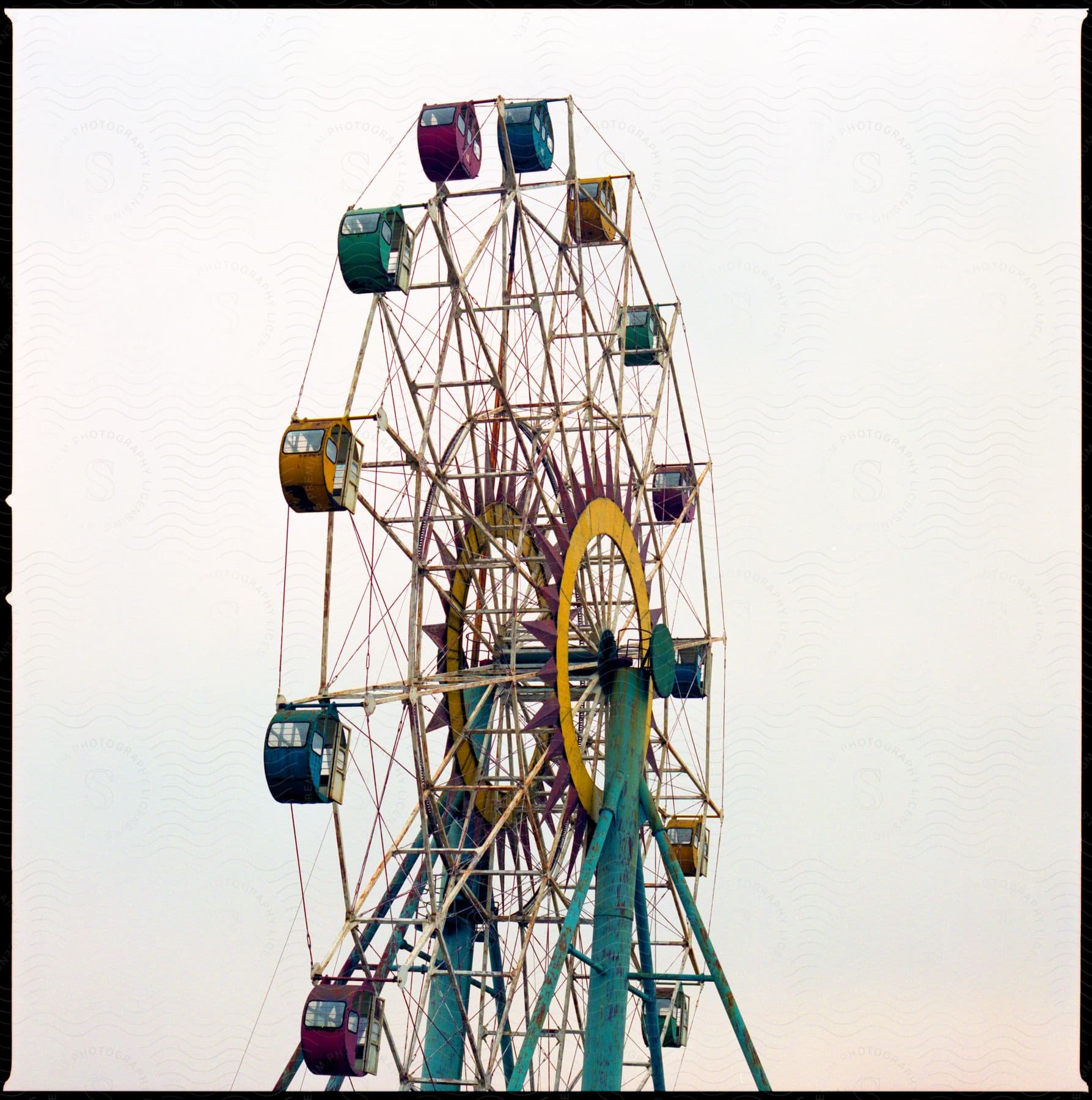 Colorful ferris wheel against cloudy sky