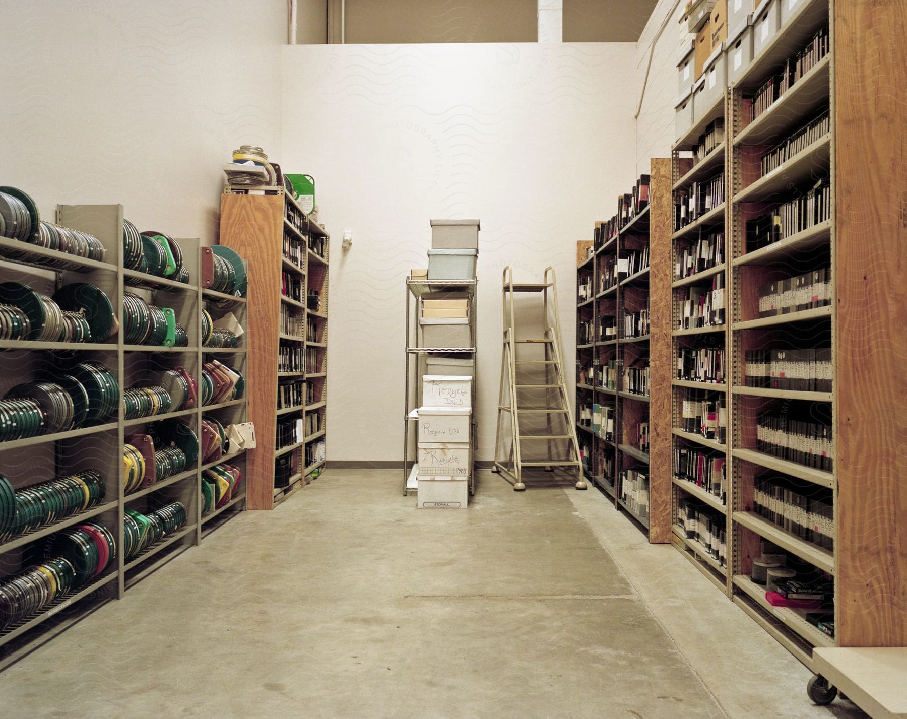 Stock photo of old media is organized in bookcases in a warehouse