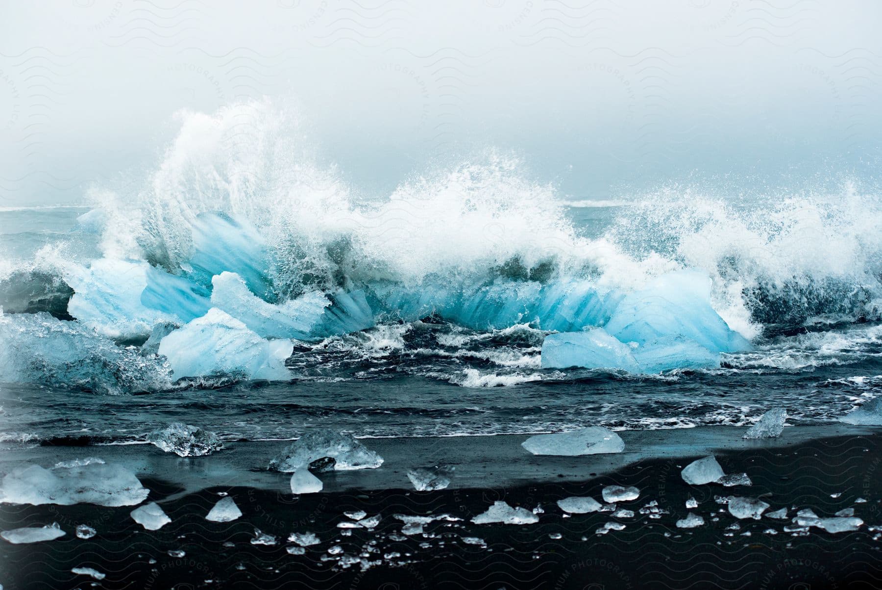 Waves crash on an ice formation in the ocean