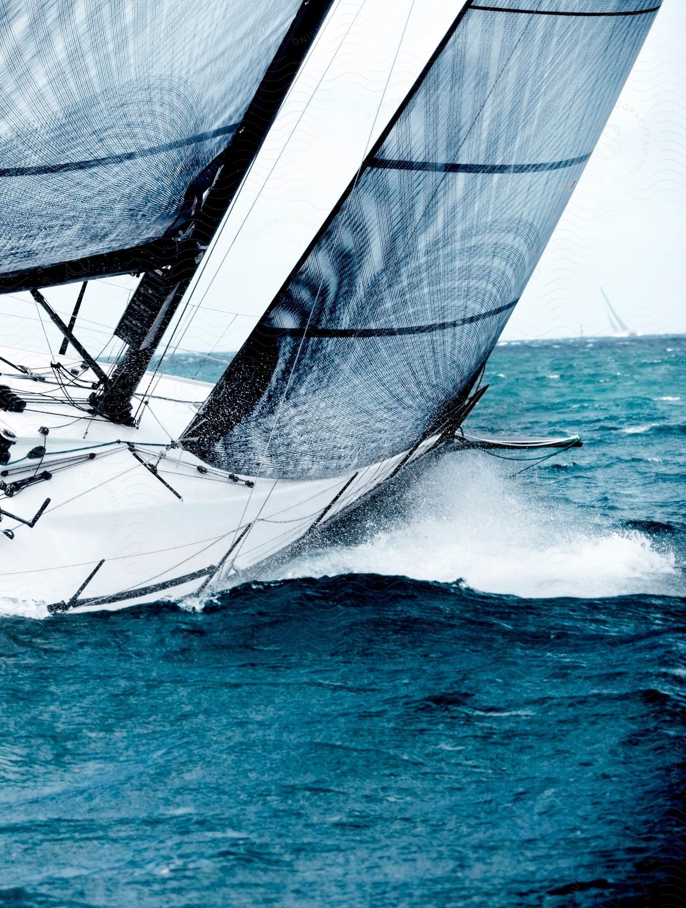 A boat is driving through ocean water during the day