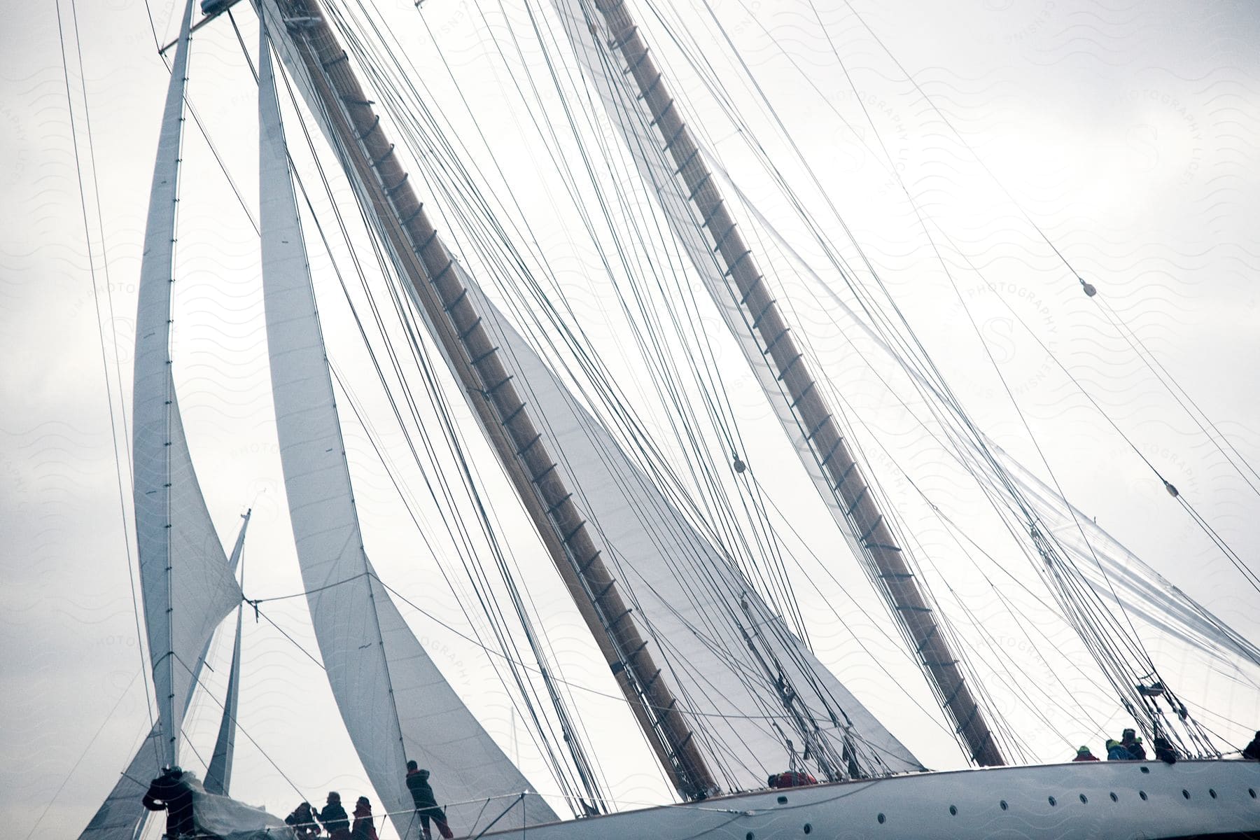 A group of people on a boat with large sails