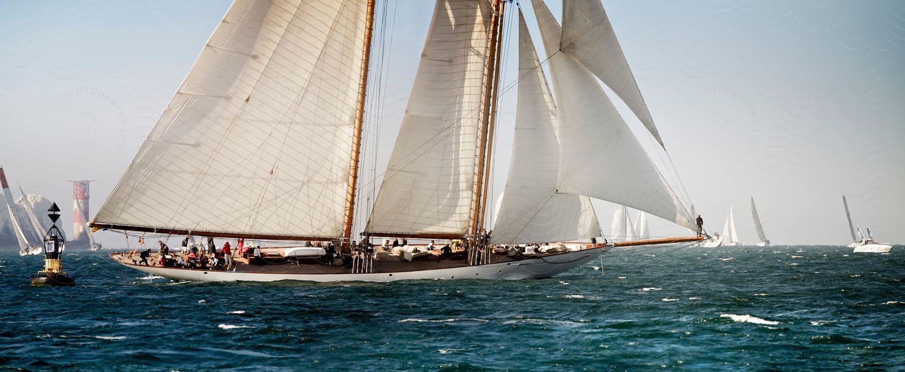 A series of sailboats in the ocean