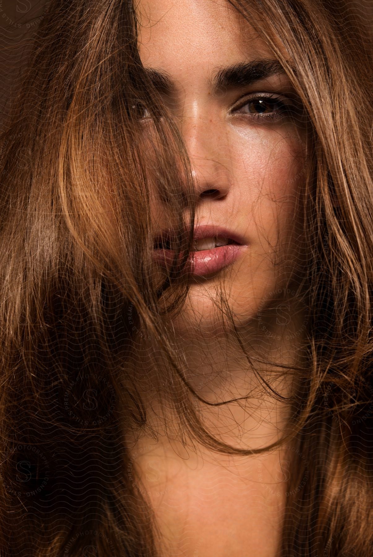 A young adult woman with layered hair neutral expression and flash photography lighting