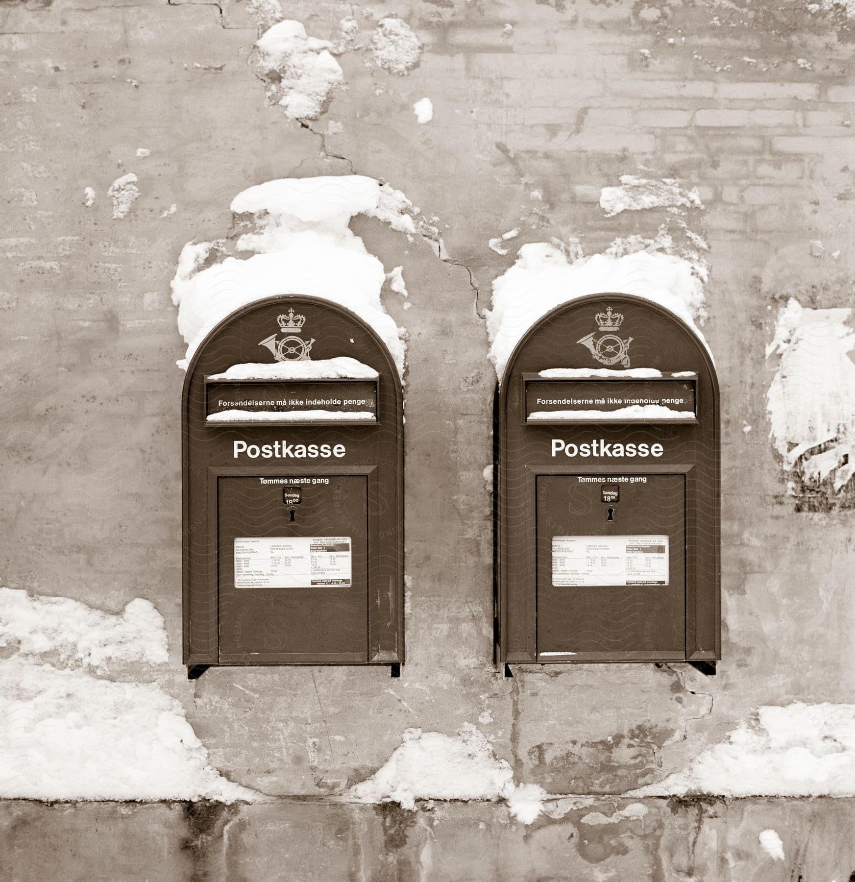 Two Mailboxes With The Word Postkasse On Them Surrounded By Patches Of Snow