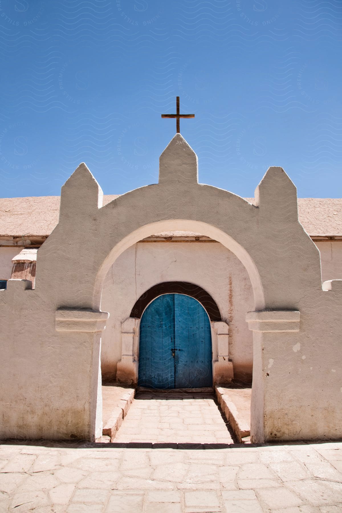 Exterior of a church with a symbol and arch