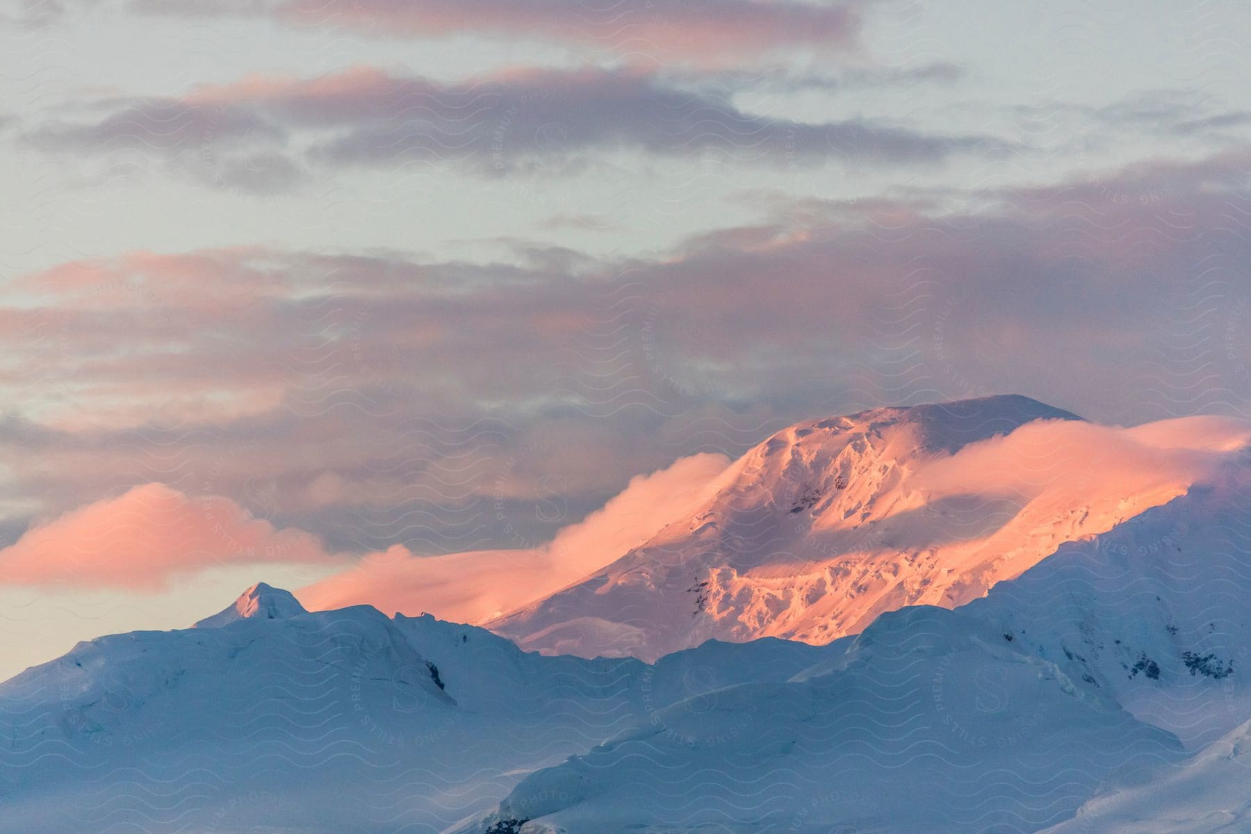 A Serene Mountain Landscape At Dusk With A Red Sky