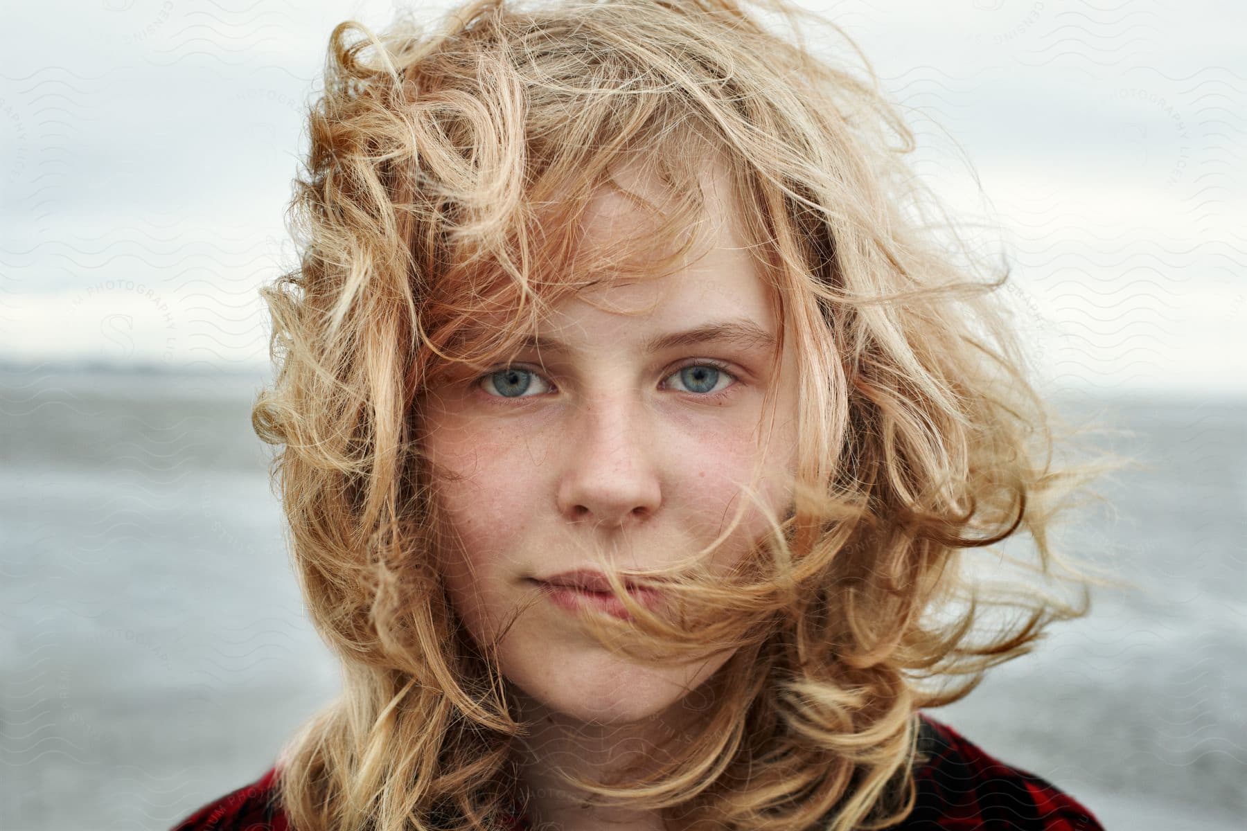 A blonde woman with blue eyes smiling at the camera