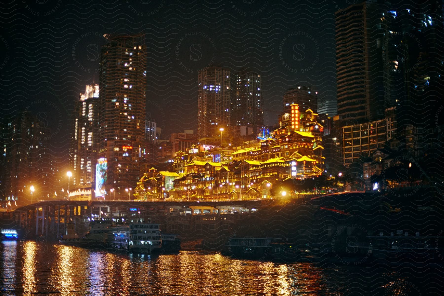 A vibrant chinese city emerges near the shoreline characterized by a skyline dominated by skyscrapers and highrise buildings