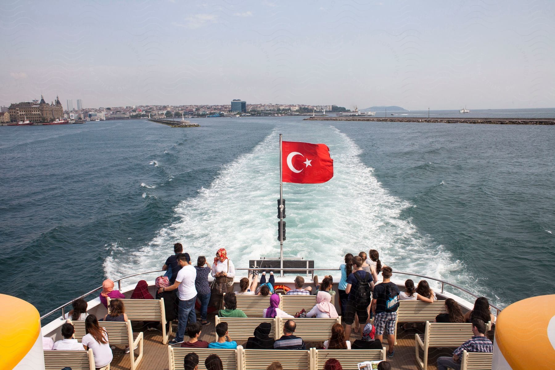 Tourist boat with many people crossing the waters near the coast