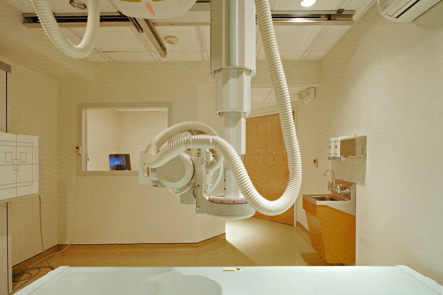 An xray machine is positioned above a table