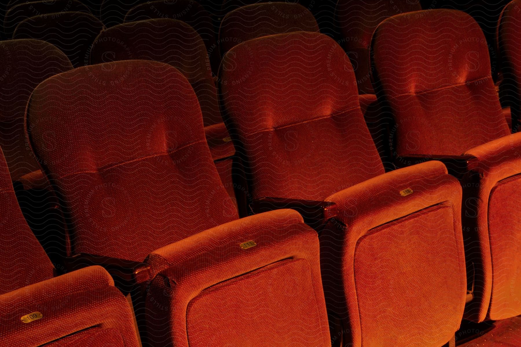 Red theater chairs with numbers on them