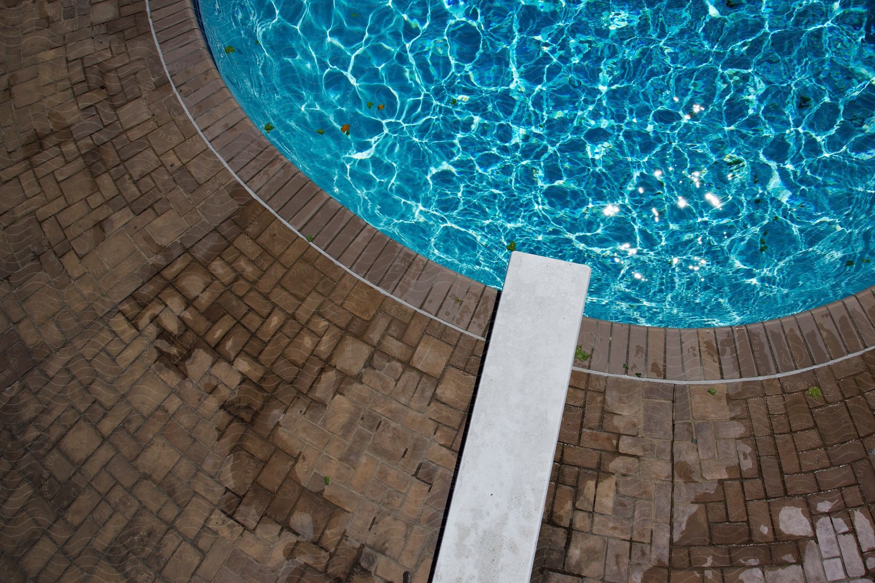 A swimming pool with a diving board