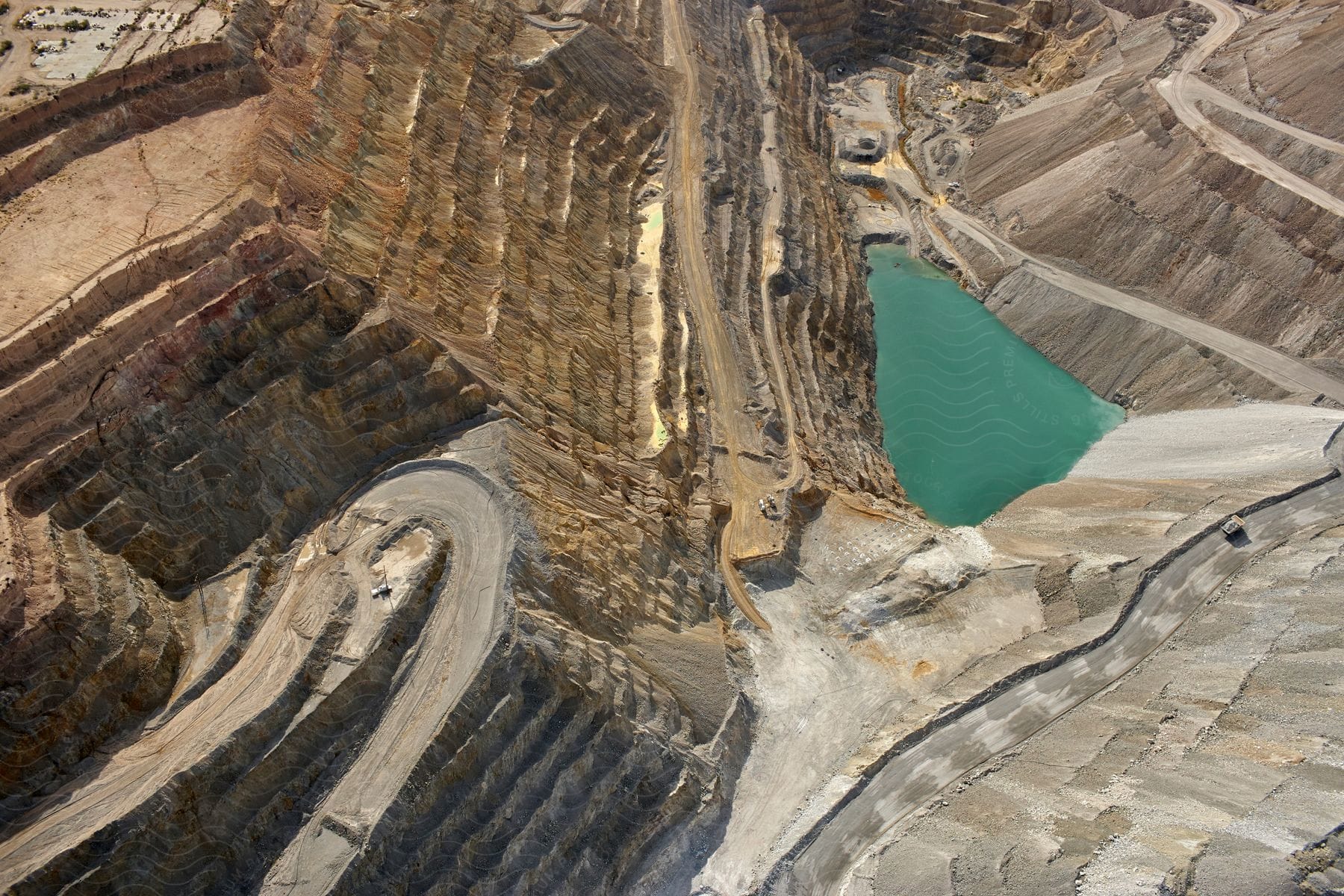 A mining rig with a small pool of water reflecting the surrounding environment