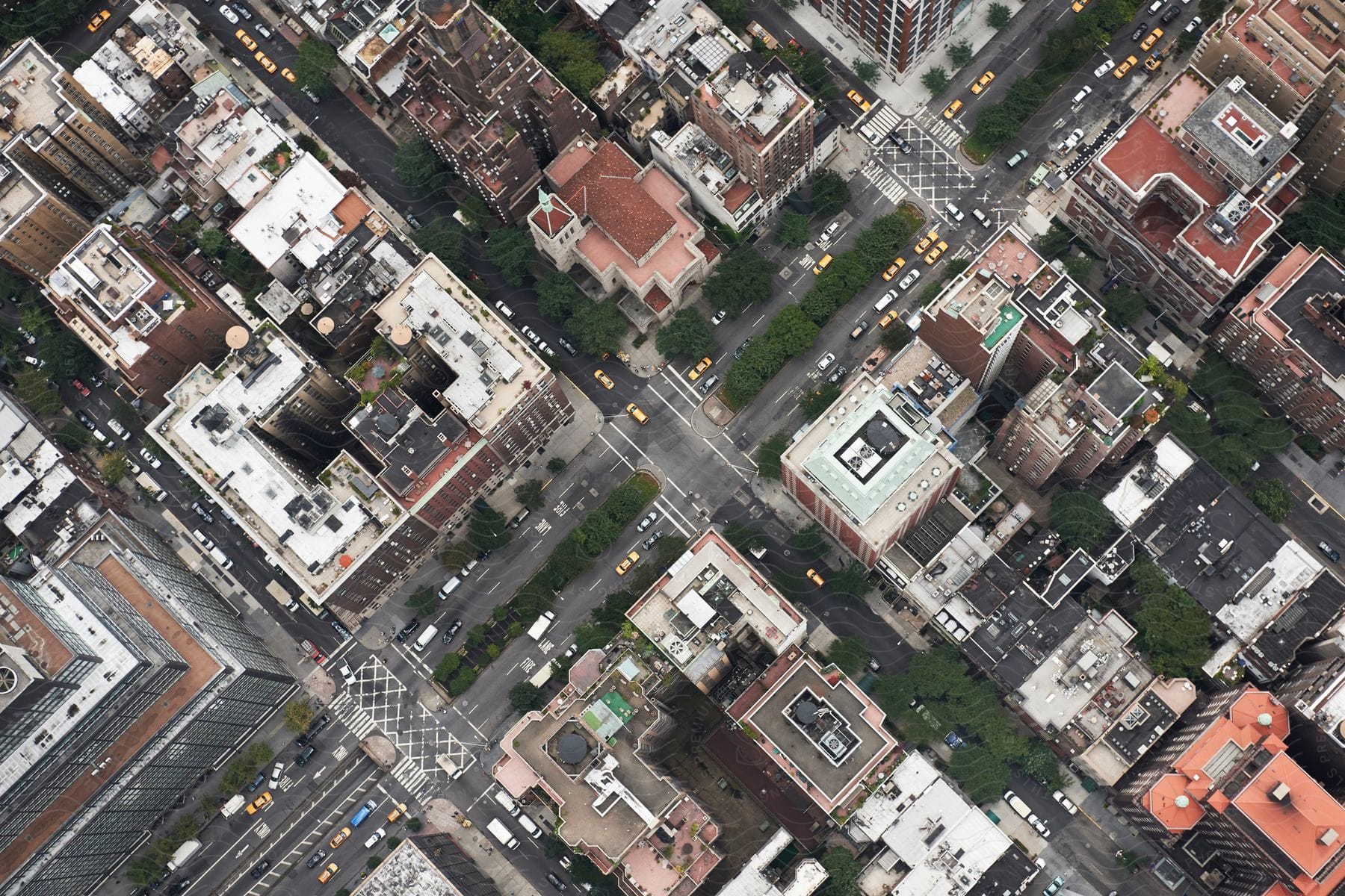 Aerial perspective of a city neighborhood with tall apartment buildings and a prominent church