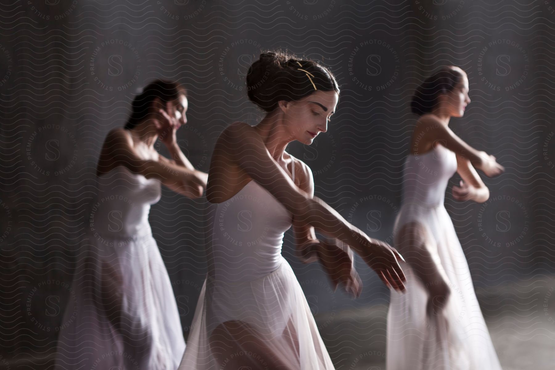 Three ballet dancers practicing a coordinated move