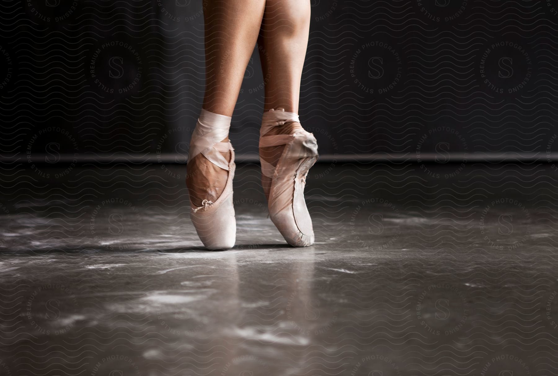 Stock photo of a ballerina stands on the tips of her toes