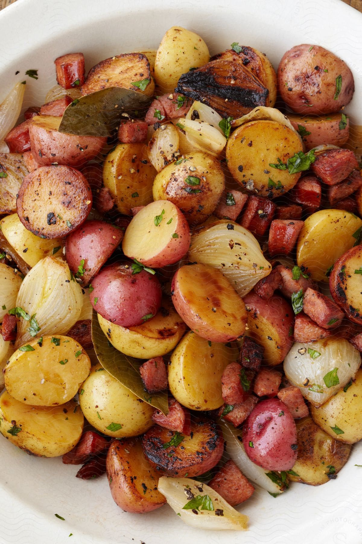 Bowl with potatoes onions and small pieces of meat