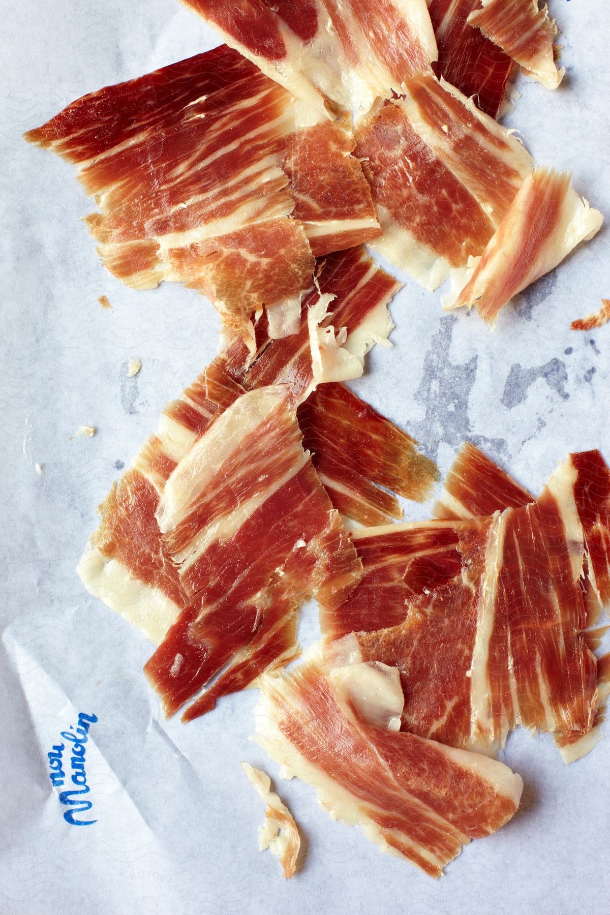 Prosciutto arranged on parchment paper