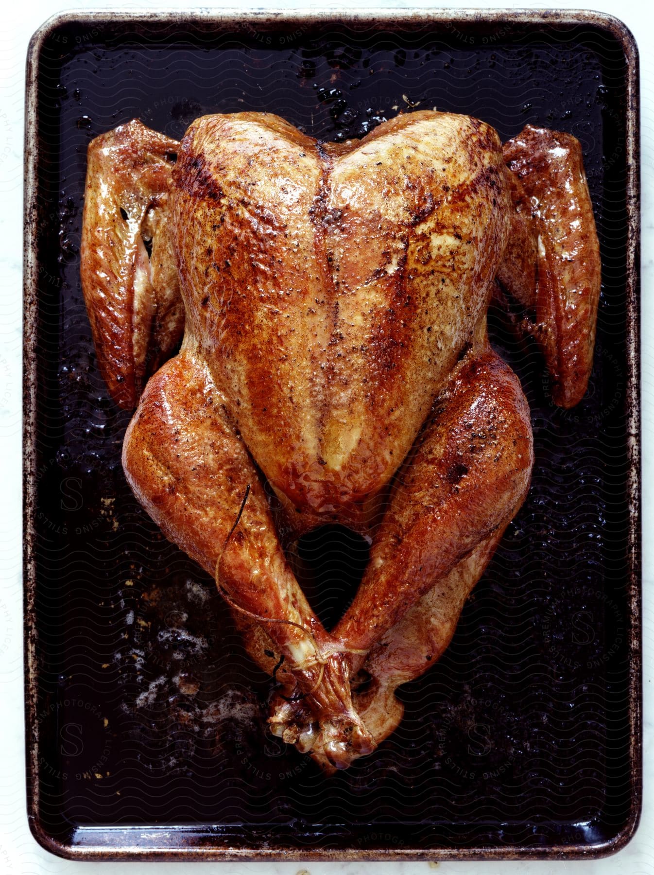 Roasted chicken on a rectangular plate seen from above