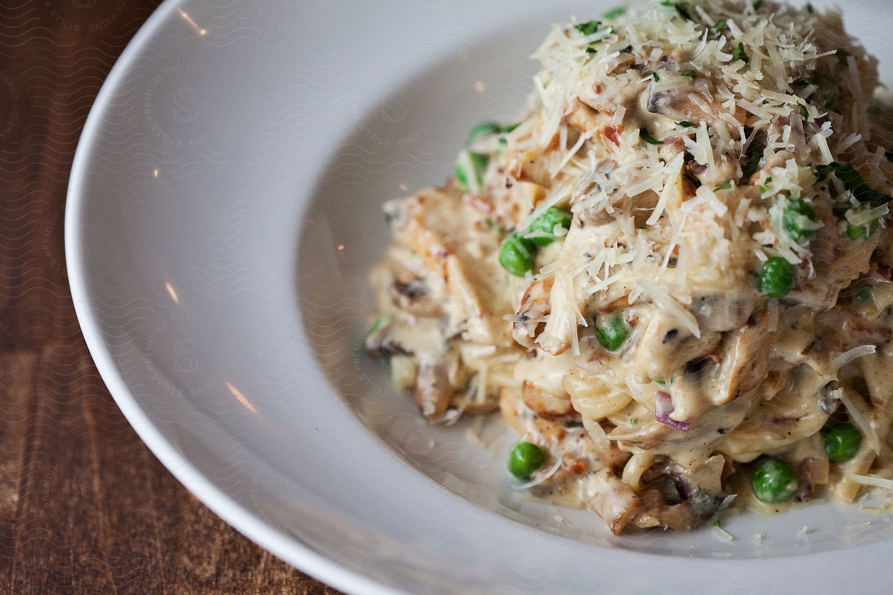 A pasta dish with white sauce on a plate