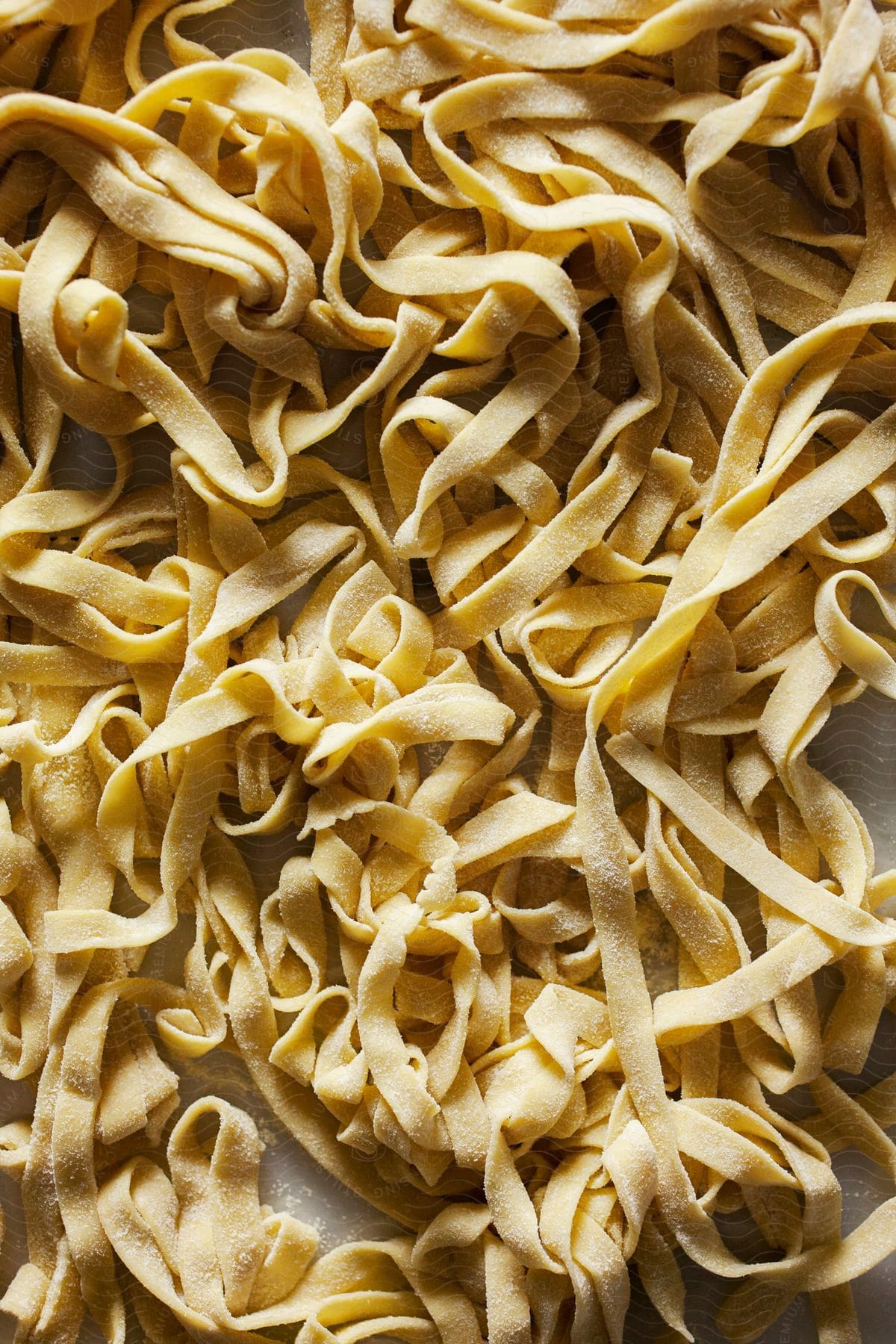 A bunch of wide pasta is bunched together