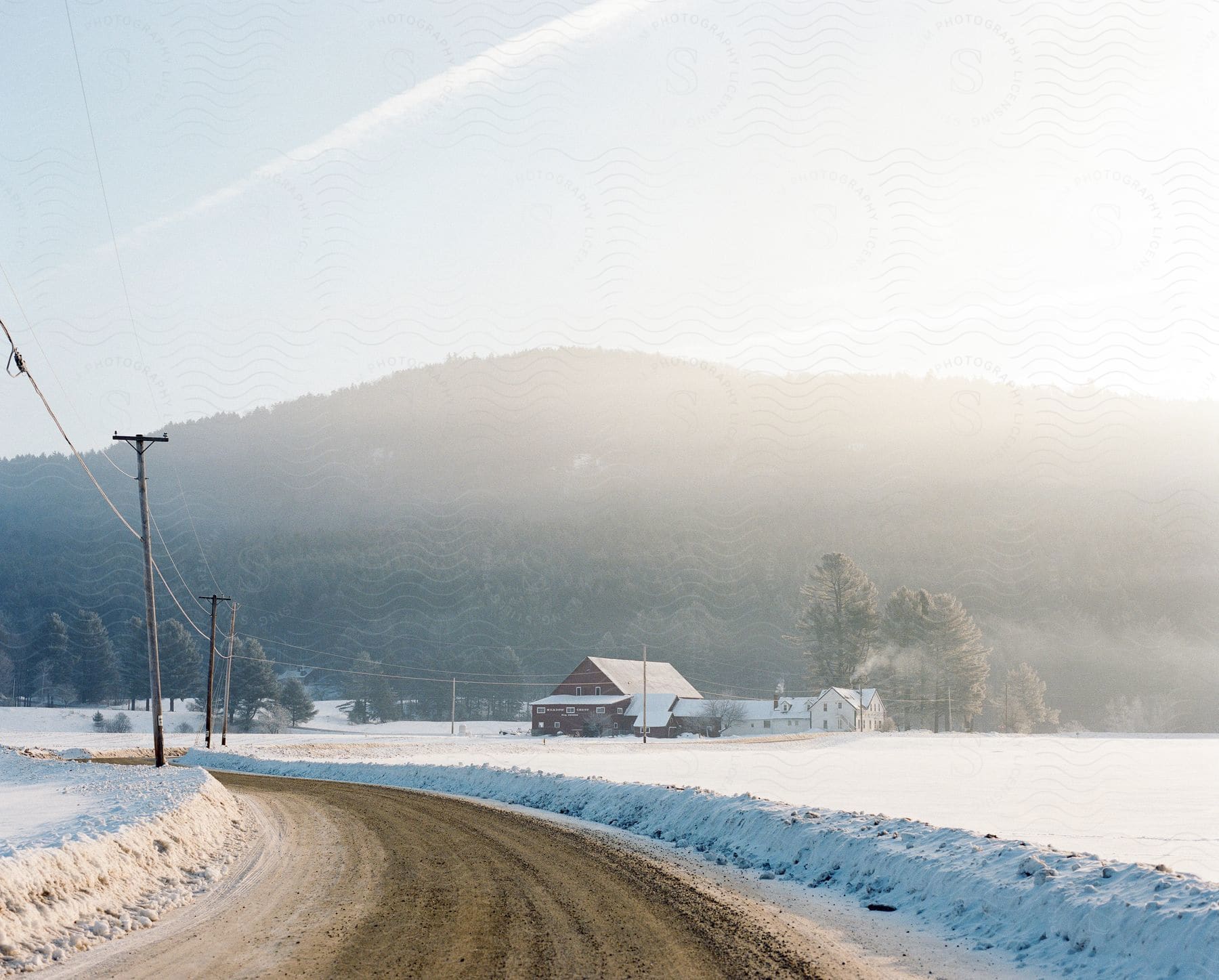 A snowy mountain landscape with houses and a street in a small town