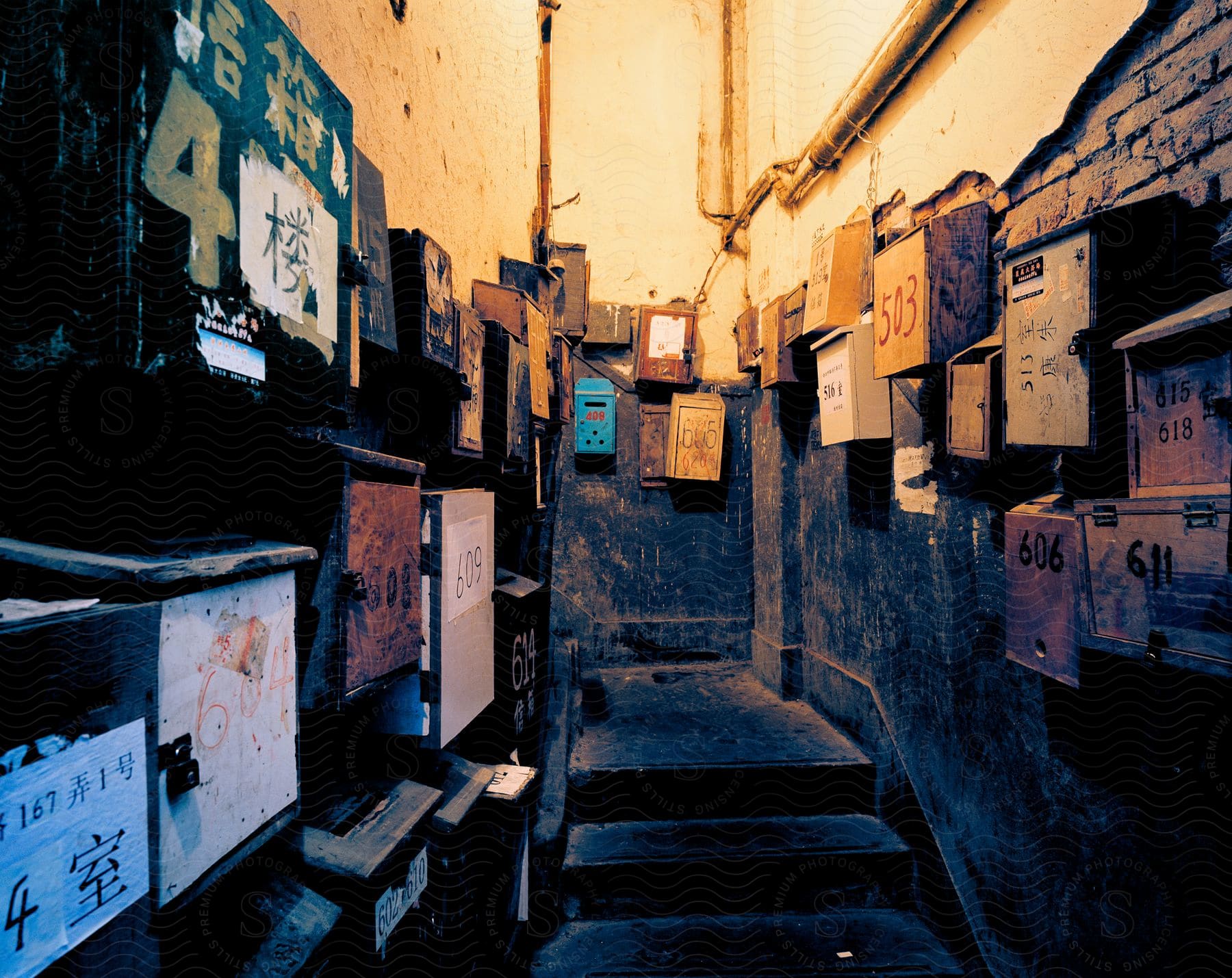 An old building with a staircase and mailboxes hanging on the wall