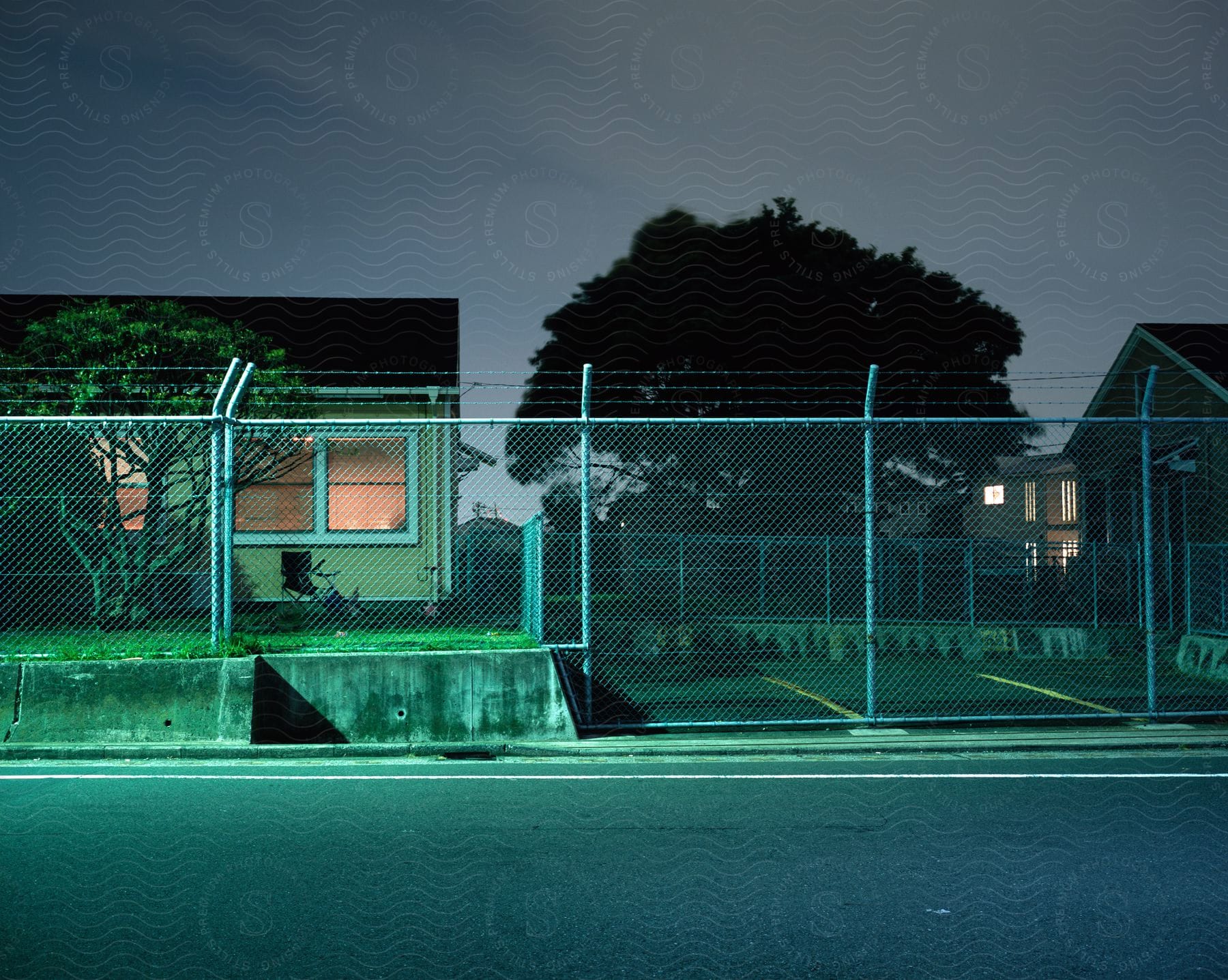 A home enclosed by a barbed wire fence for security purposes